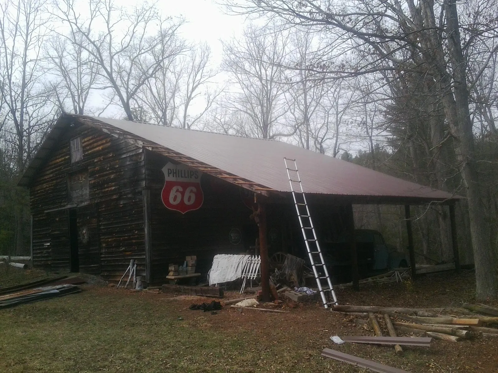 New metal roof on an open sided timber barn with a vintage sign in Basalt